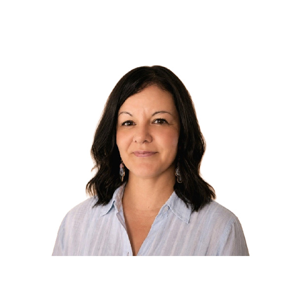 Woman with medium-length dark hair wearing a light blue blouse and earrings, smiling slightly, posed against a plain white background.