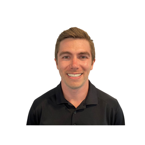 Smiling man with short brown hair, wearing a black collared shirt, posed against a plain white background.
